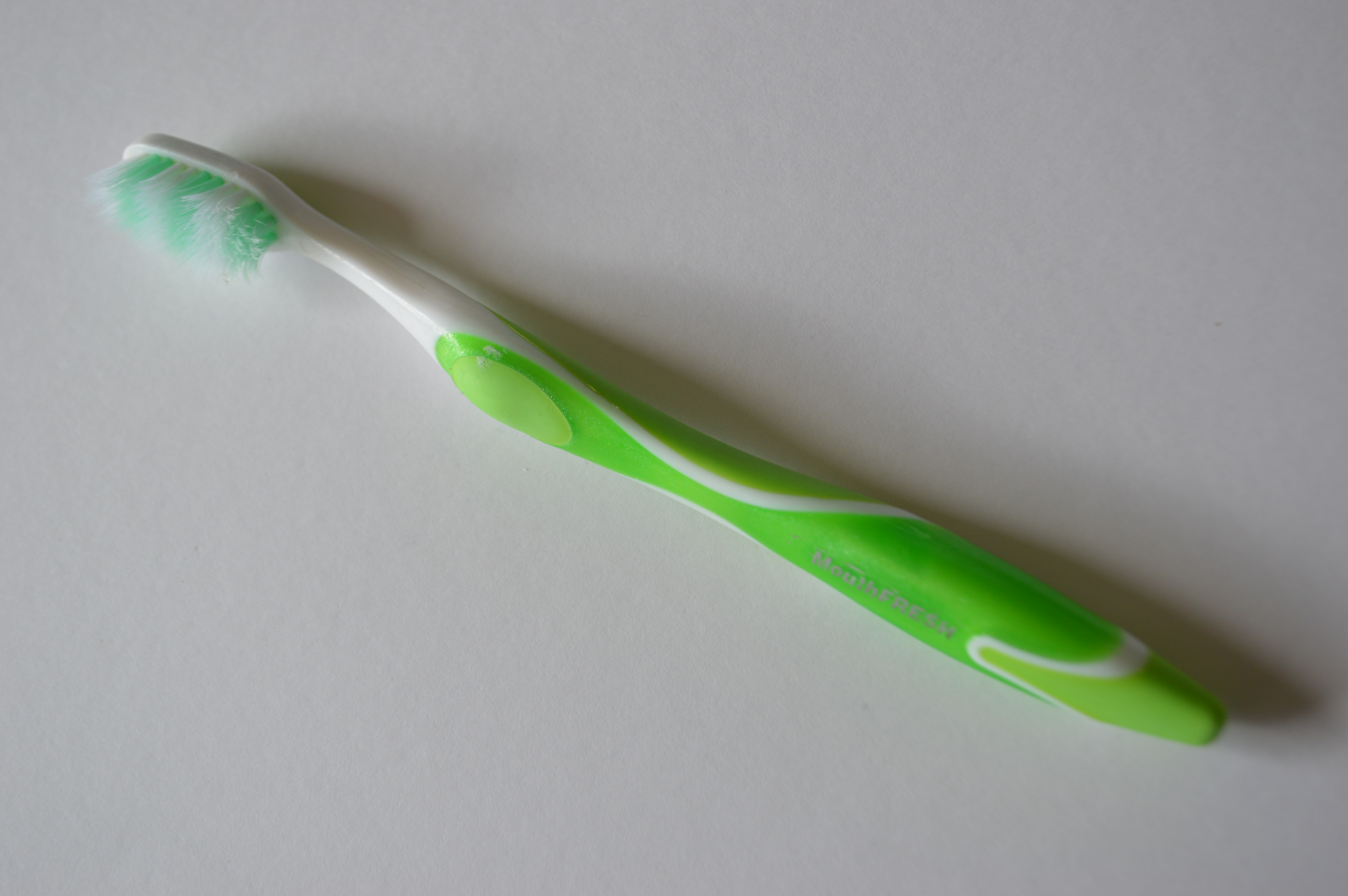 Image of a green plastic toothbrush